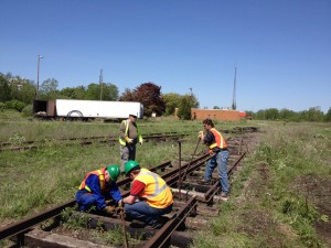 Setting up the tow chain to move the out of position rail with the tractor.